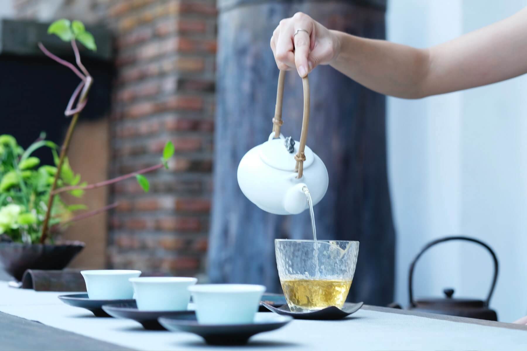 woman is pouring chai tea