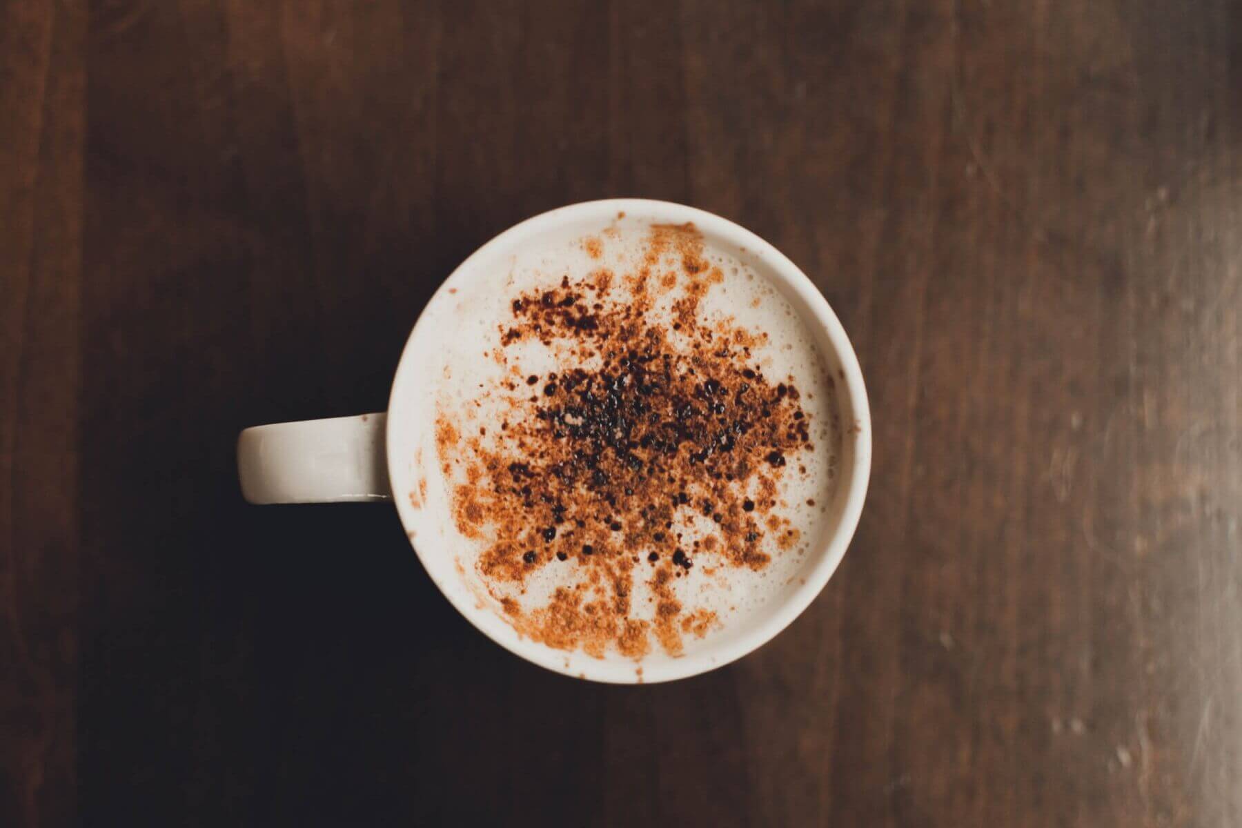 A creamy almond milk cappuccino sprinkled with cinnamon and chocolate.